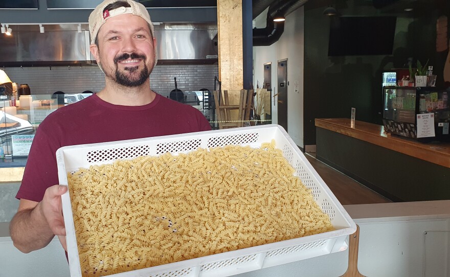 Mason shows off a finished batch of fusilli.