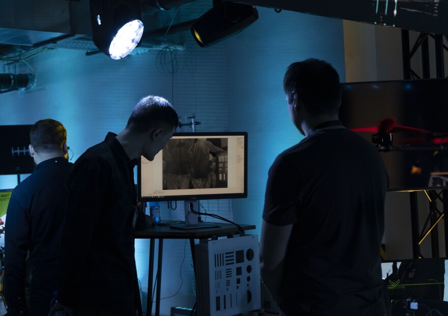 Observers look over an exhibition featuring some of the Ukrainian technologies being used on the battlefield as a part of a presentation of the new so-called BRAVE1 initiative, held in an underground parking lot in Kyiv, Ukraine, Wednesday, April 26, 2023. The Ukrainian government on Wednesday launched the initiative meant to streamline and promote innovation in the development of drones and other technologies that have been critical in the war with Russia.