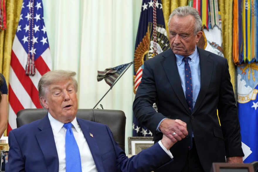 President Donald Trump, left, shakes the hand of Health and Human Services Secretary Robert F. Kennedy Jr. during a meeting to sign an executive order about vaccines Monday in the Oval Office of the White House.