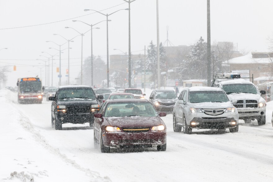 Cars driving in the middle of winter storm 