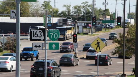 Cars drive through a stoplight on the Business Loop in Columbia, MO. 