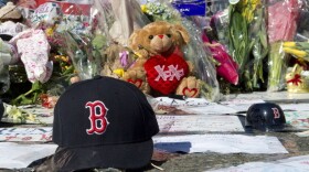 A Boston Red Sox cap left at a makeshift memorial on the Boston Marathon route.