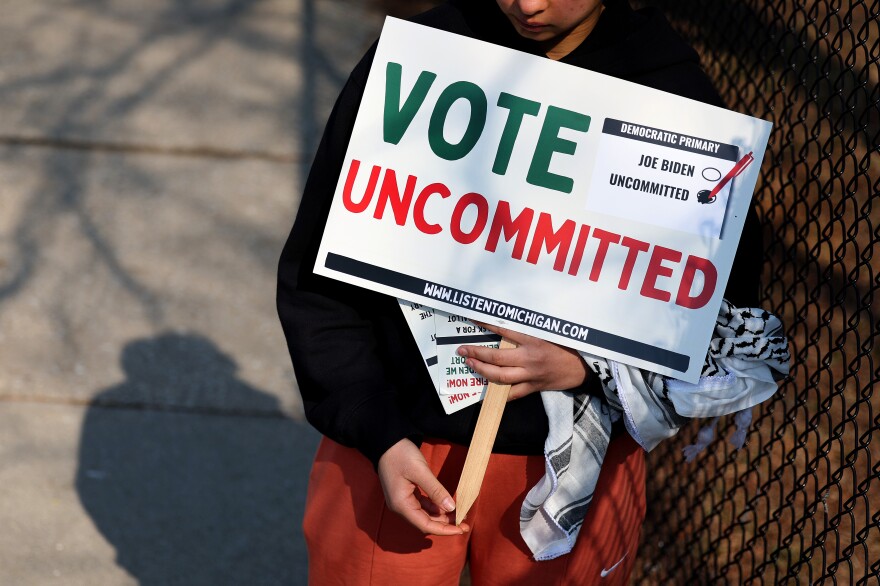 A Democratic voter uncommitted to President Joe Biden rallies outside of a polling location at Maples Elementary School on February 27.