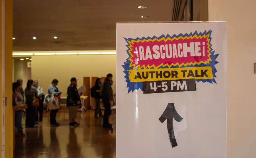 People waited in line for López to sign the books they purchased.