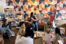 Jessica Knight reads to the children that participated in the Morning Book Club and Poetic Republic, a coffee shop in Southtown. Imagination Library sponsored the gathering.