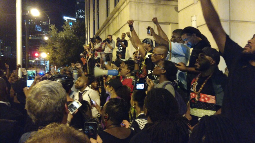 Protesters gather outside of CMPD headquarters, chanting, "release the tapes."