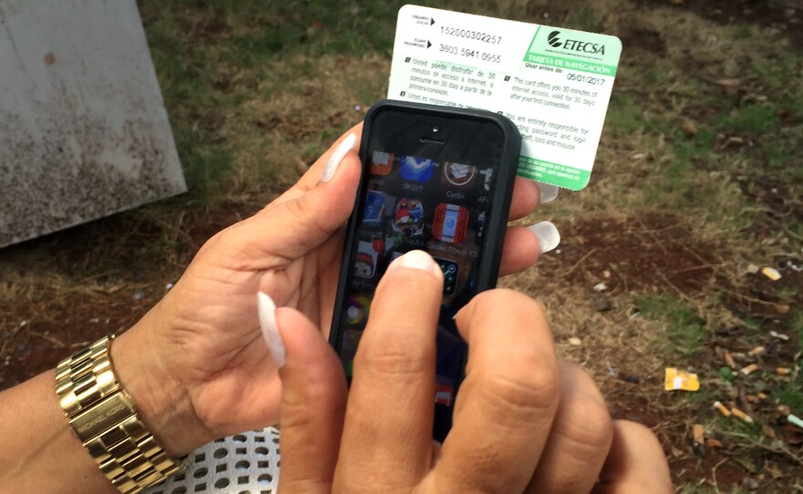 Mari Jimenez, 53, uses an Internet access card sold by the state phone company.