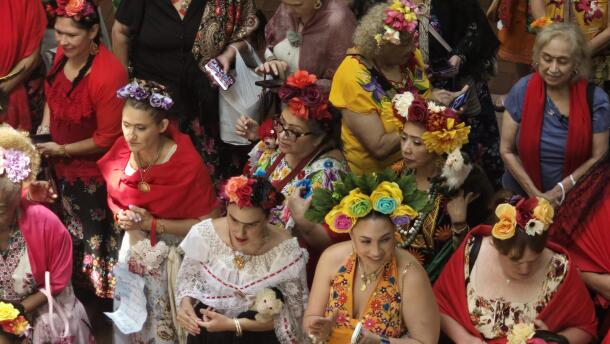 An array of Friday look-alikes line up by the stage before a promenade across the stage for happy fans and family.