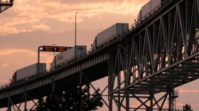 Semi-trucks wait in line to enter the United States in Port Huron, Mich., across the Blue Water Bridge from Sarnia, Ontario Monday, July 20, 2026.