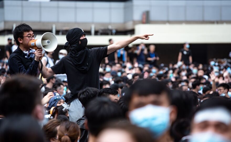 Protesters occupy the roads near the Legislative Council and government headquarters in Hong Kong on Wednesday as Hong Kong authorities delayed the second reading of a controversial bill allowing extradition to mainland China.