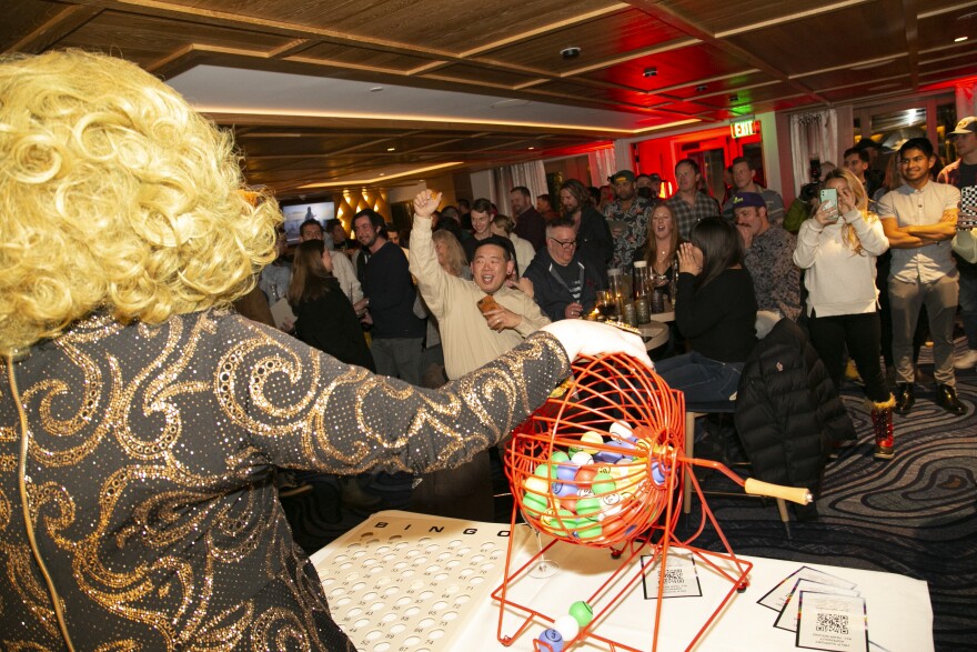 Drag queen Mariam T, left, prepares to announce bingo numbers at Aspen Gay Ski Week's Drag Queen Bingo on Tuesday night for the crowd gathered at the W Aspen.