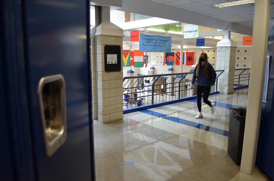  A masked student walks the hallway at Worthington Kilbourne High School in March 2021, as students came back to in-person learning with a mask mandate in place. [Daniel Konik /  Statehouse News Bureau]