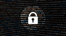 Image of a lock in front of a computer screen with code