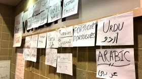 Houston Immigration Legal Services Collaborative is set up at the NRG Center, with several posters that hope to welcome undocumented immigrants and encourage them to get help. (Stella M. Chavez/KERA News)