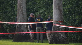 Law enforcement personnel continue to investigate the area around Trump International Golf Club after an apparent assassination attempt on former President Donald Trump in West Palm Beach, Florida.