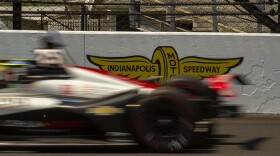 Stefan Wilson speeds past an Indianapolis Motor Speedway logo during practice for the Indianapolis 500 on Friday, May 20.