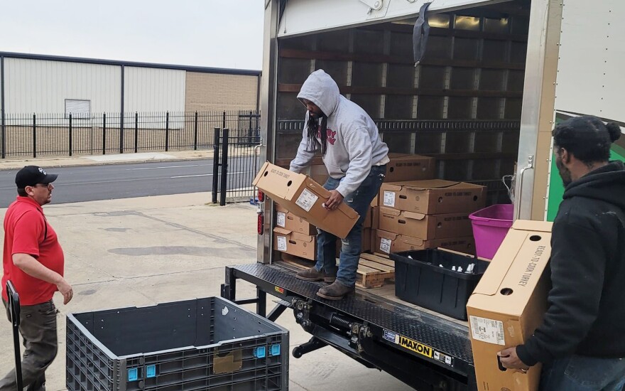 Founder Joey Thomas seen taking boxed turkey off the back of a pickup truck
