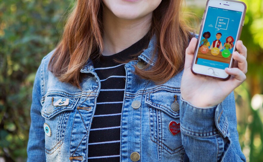 Natalie Hampton shows off the Sit With Us app.