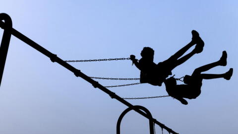 Children play on swings during National Night Out, Tuesday, August 1, 2023, in Salisbury, Maryland. (Julia Nikhinson/AP)