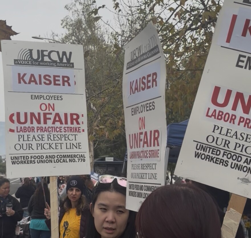 Image of workers with picket signs outside of a Kaiser Hospital in Ontario, California. 