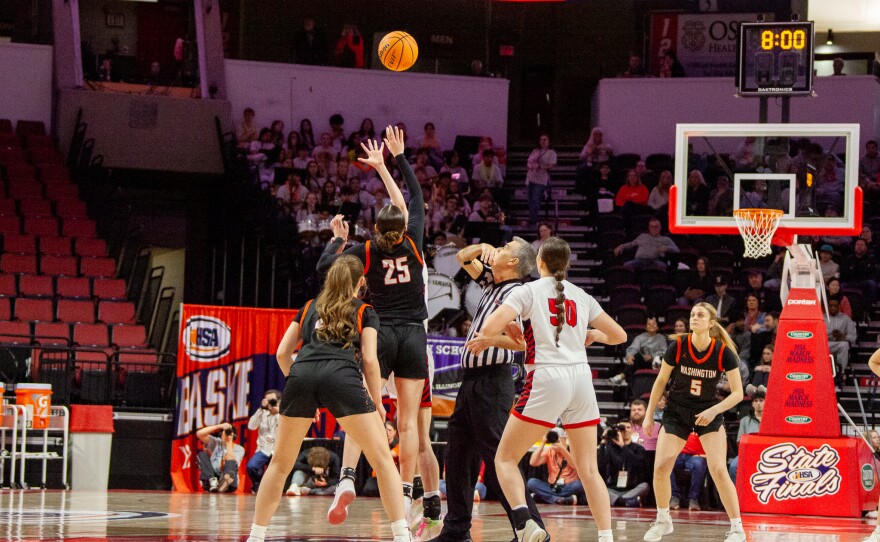 Girls high school basketball players inside an arena