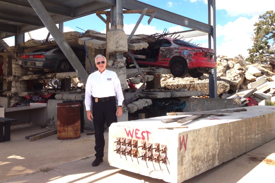 David Martin, director of rescue training at "Disaster City," stands in front of a mock-up of a government building that's been hit by a bomb.