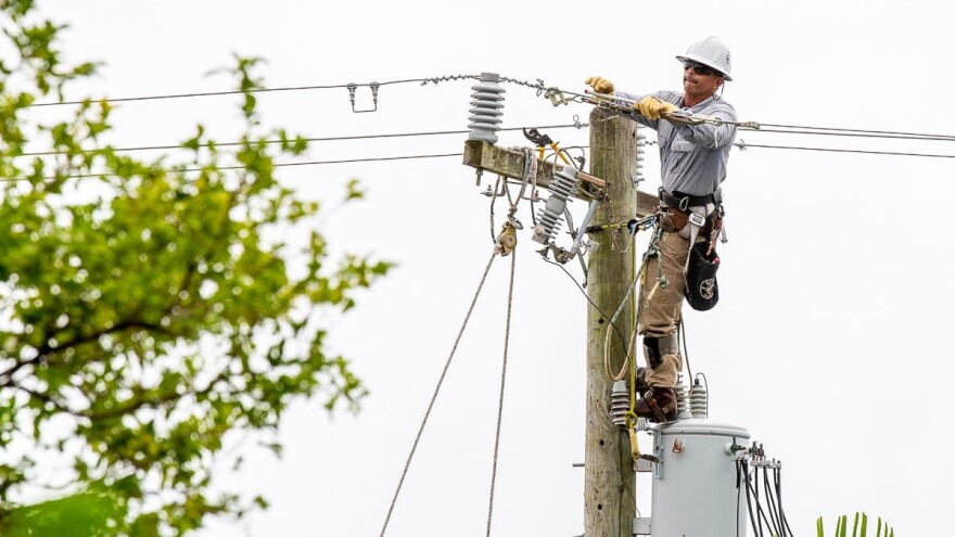 FILE - An FPL lineman works to repair power lines in Key Biscayne, Wednesday, Sept 28,2022. About 3,700 customers lost power, including government offices. Power was largely restored by mid-afternoon.