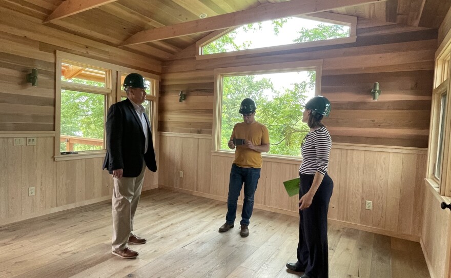 Lakeshore Public Media President and CEO Chuck Roberts along with Tony Santucci, Vice President of Production listen as Opportunity Enterprises Donor Relations Manager Jane Kobak outlines plans for the new Lakeside Respite Center treehouse. The treehouse was built in partnership with Nelson Treehouse of the popular cable television show Treehouse Masters.