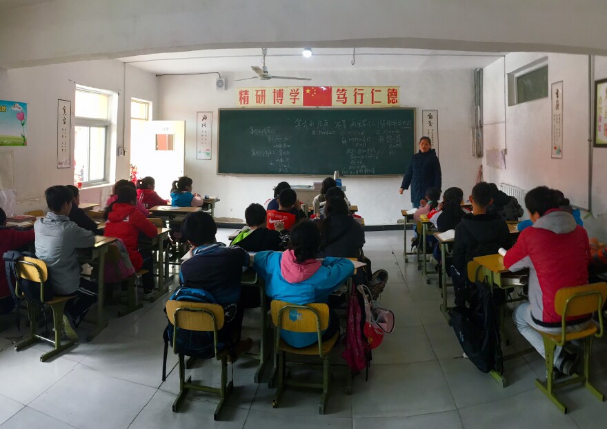 Children whose parents have migrated from elsewhere in China sit in a classroom at a private school in Beijing. They are officially still citizens of the rural areas their families come from and not eligible for public education elsewhere.