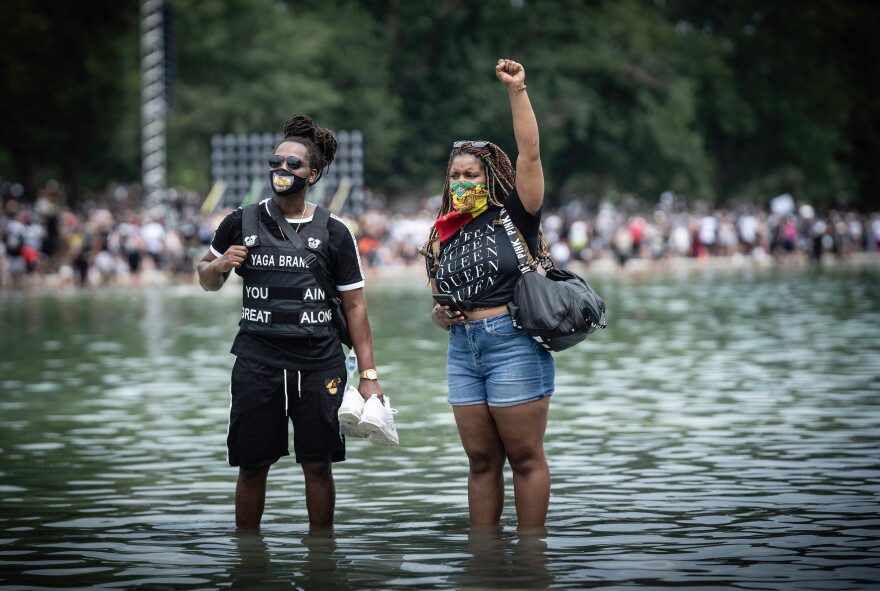 March participants cool off in the Lincoln Memorial Reflecting Pool.