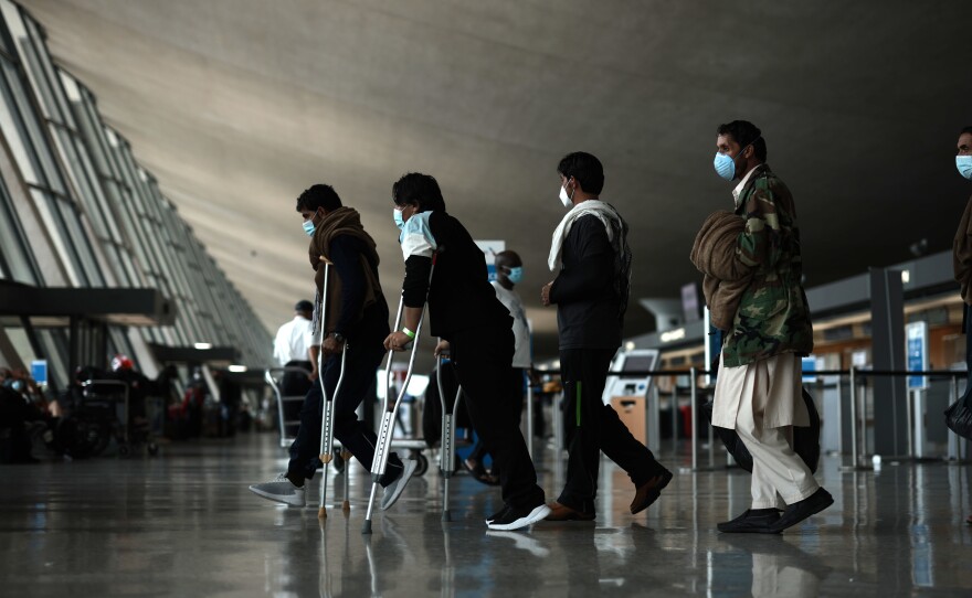 Refugees are seen at Dulles International Airport in Virginia on Tuesday after being evacuated from Kabul following the Taliban takeover of Afghanistan.