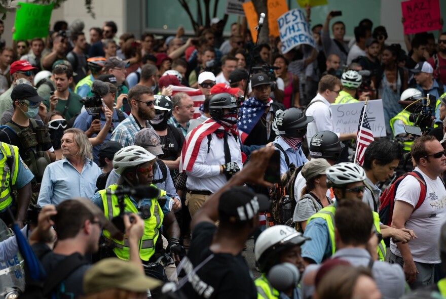 Police escort demonstrators during the Unite the Right 2 rally.