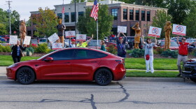 Community members protest potential data center developments in Mason, Mich., before a town hall meeting with city officials on Sept. 14, 2026.