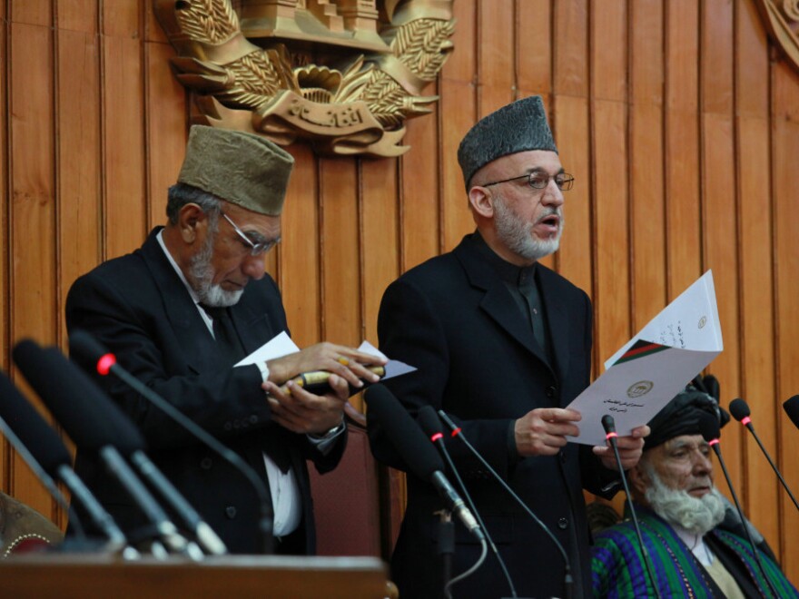 Afghan President Hamid Karzai (center) gives the oath to members of Afghanistan's new Parliament in Kabul on Jan. 26. His government set up a special tribunal to re-examine the results of elections — marred by irregularities and charges of fraud — and Parliament bristled at what it saw as an overreach by the executive.