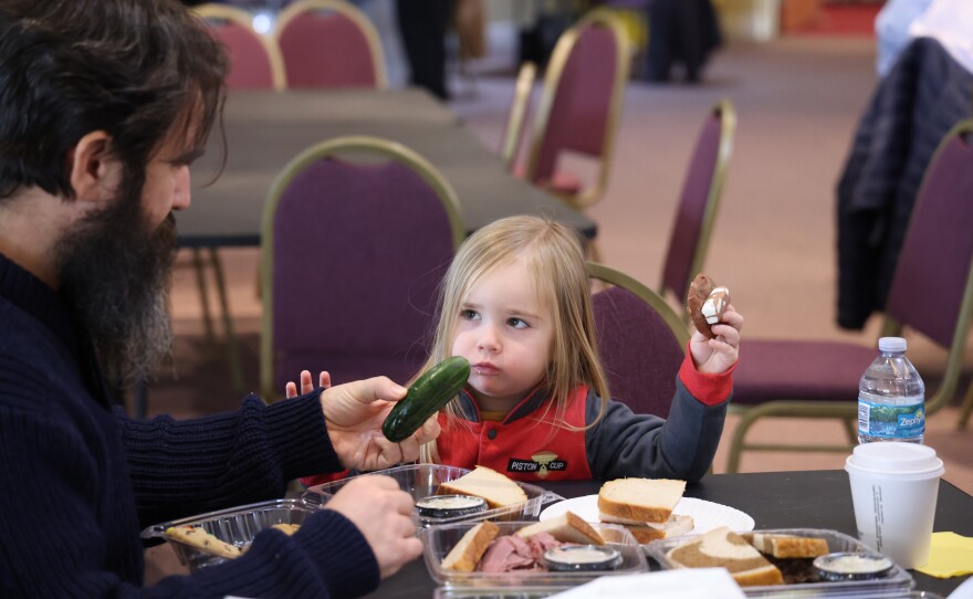 Three-year-old Claude choose his cookie over the pickle his father, Nicholas Morganti, offered him. The 18th Annual Jewish Food Festival at Temple Sinai in Sarasota was held this Sunday, Feb 1, 2026. Brisket, pastrami and corned beef sandwiches were served by local restaurant Wolfie’s. As well as baked goods, matzoh ball soup, strudels and more.The Temple served up a celebration of flavors and traditions of their community.