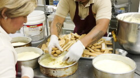 Jesus Pina assembles a tiramisu cake at Las Delicias Bakery on Central Avenue in Charlotte. Business there is down since President Trump's January immigration orders. 
