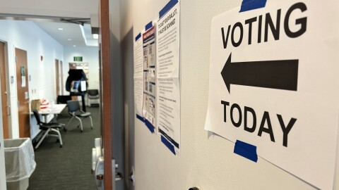 A sign directs voters to their polling location inside a library in Columbus.
