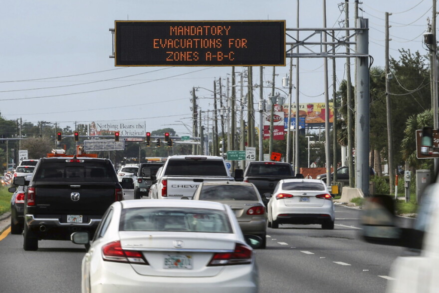Highway signage announces the impending arrival of Hurricane Milton and the evacuations zones on Tuesday, Oct. 8, 2024, in Port Richey.