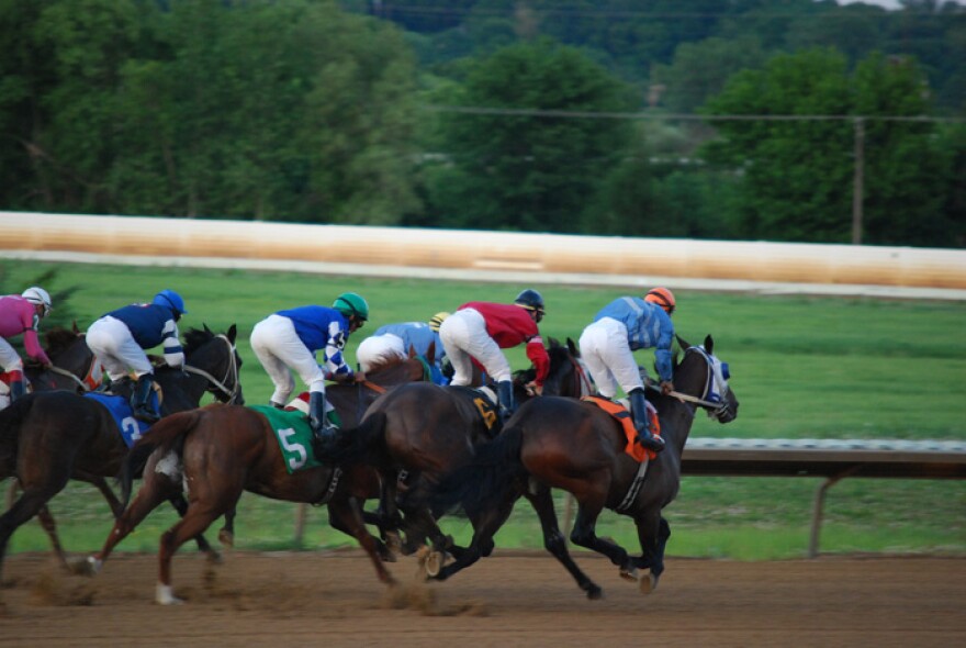 Horses race around the track at Fairmount Park Racetrack in Collinsville, Ill.