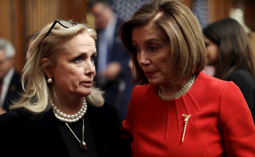 Speaker Nancy Pelosi talks to Rep. Debbie Dingell in the Capitol on Dec. 19.