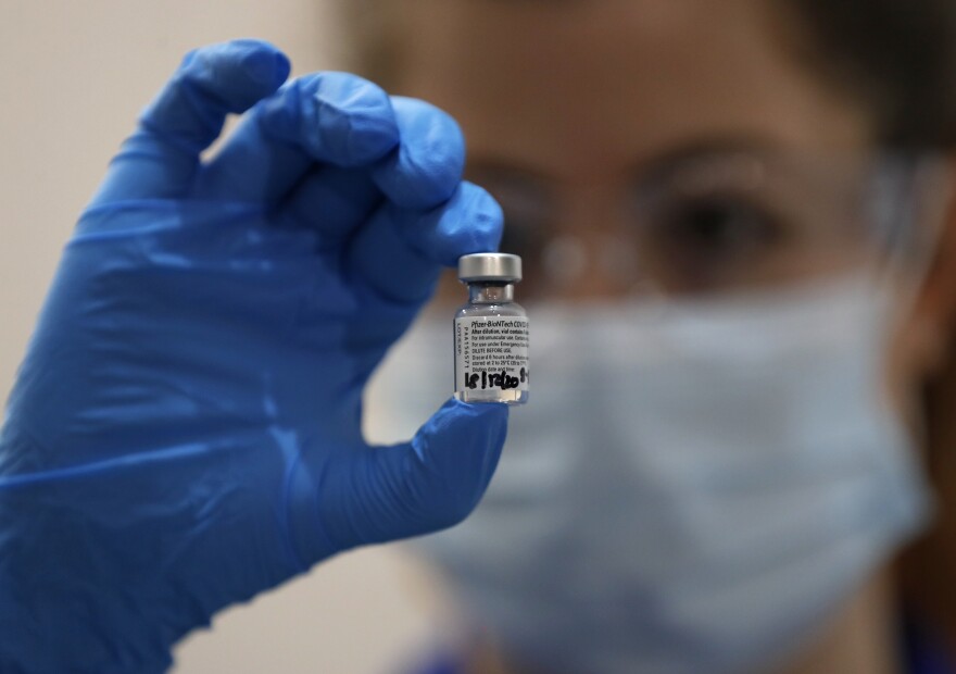 A nurse holds a phial of the Pfizer-BioNTech COVID-19 vaccine at Guy's Hospital in London, Tuesday, Dec. 8, 2020. On the same day, Penn Highlands Healthcare said it expects to receive its first batch of vaccines in two weeks.