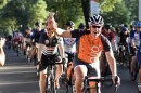 A cyclist waves a cowbell during the 24 Hours of Booty event in Charlotte on July 26, 2019.