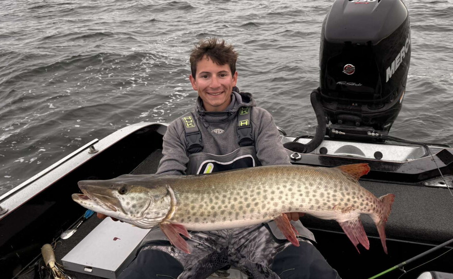 Bemidji State University graduate student Baylor Short shows a muskie caught on Leech Lake.