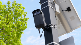 A solar-powered urban surveillance camera is mounted on a pole in this file photo.