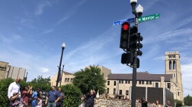 Aurthur Mae Perkins, left, joins family members in admiring the honorary street sign recognizing her commitment to Peoria during a ceremony Thursday at the corner of Hamilton and Monroe Streets.