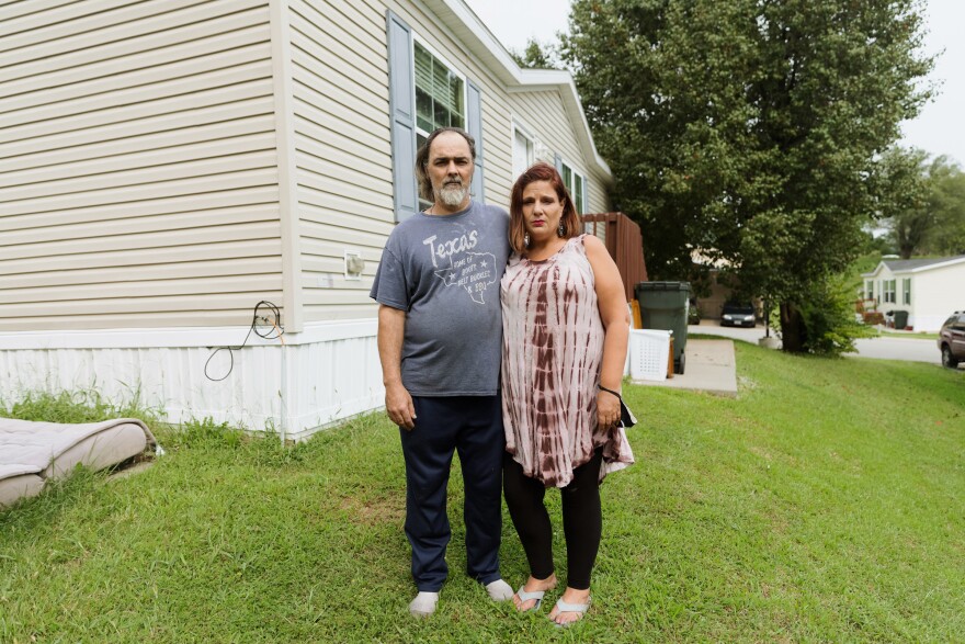 Joseph and Angela Alvelo in front of the home she rents at Lakeview Terrace, a mobile home park in Kansas City, Missouri.