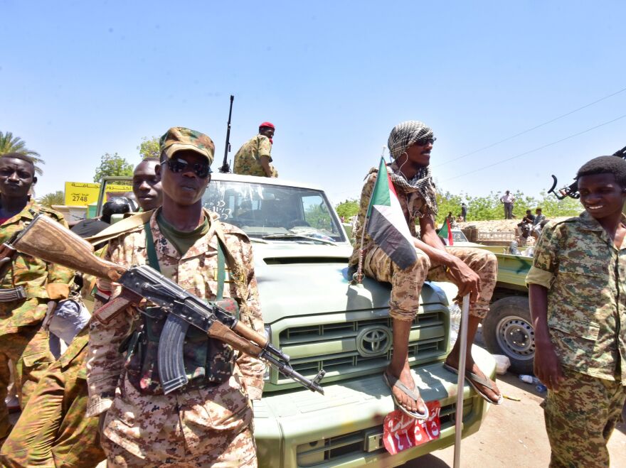 Sudanese armed forces gather near the site of a demonstration close to the military headquarters in Khartoum on Monday.