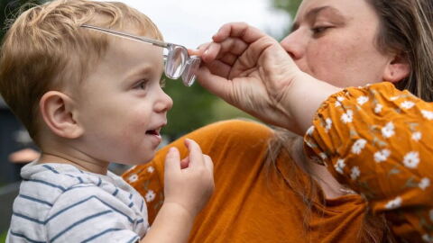 Cassidy Friedl puts glasses on her son Luca, 20 months, at the home they share with her parents in West Suffield.