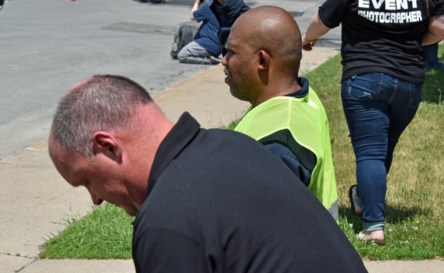 Plattsburgh Police Chief Levi Ritter (foreground) joins the crowd in kneeling for 8 minutes 46 seconds