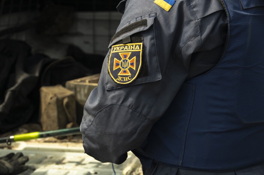 Maksim's State Emergency Service patch can be seen as he prepares to detonate another unexploded timed mine.